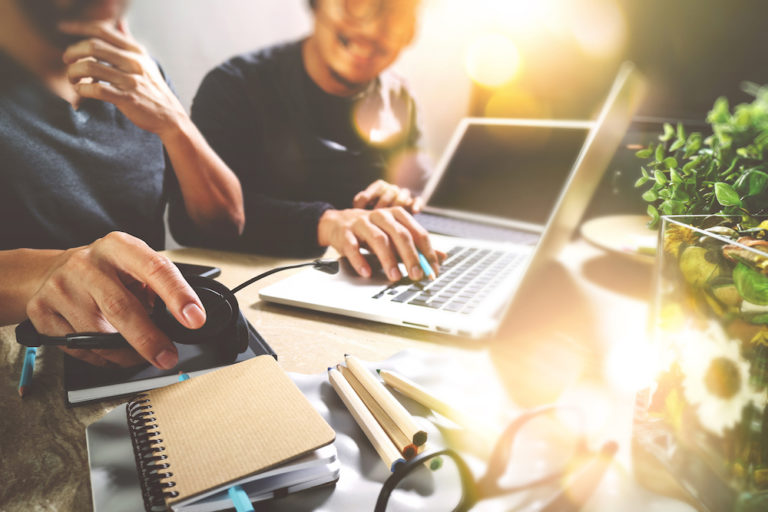 Two guys working on laptop