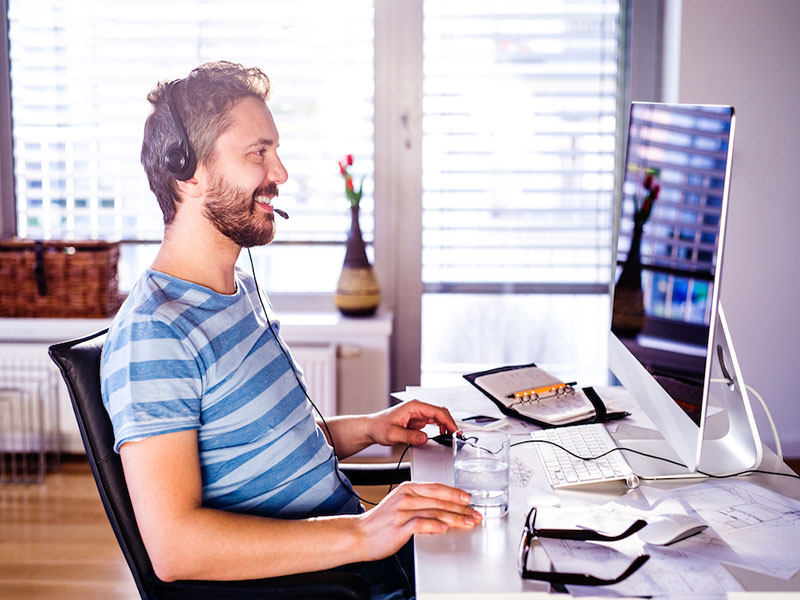 Smiling man working on the remote work station, Maryland